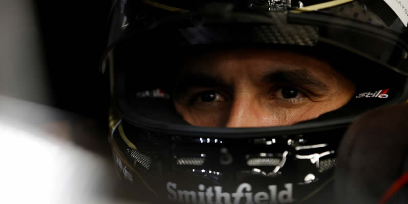 Aric Almirola sits in his car in the garage area during practice