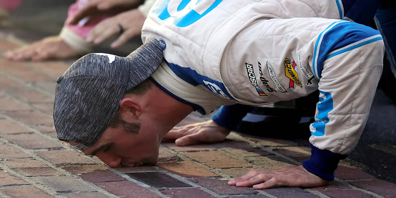 Austin Cindric kissing the bricks at the Brickyard at Indianapolis Motor Speedway 