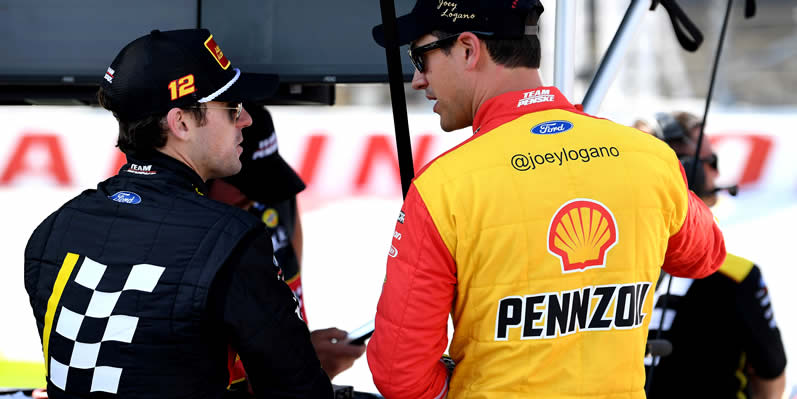 Ryan Blaney and Joey Logano talk on the grid during practice