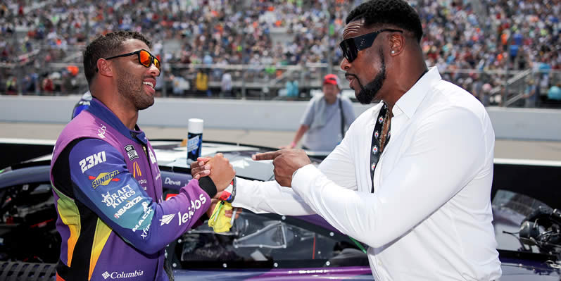 Actor Chris Tucker shakes hands with Bubba Wallace