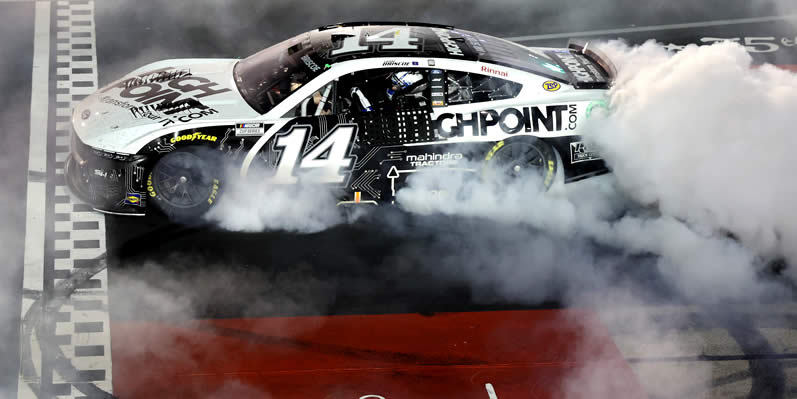 Chase Briscoe celebrates with a burnout after winning