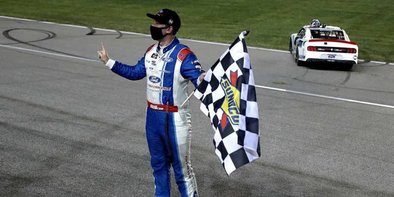 Chase Briscoe celebrates with the checkered flag