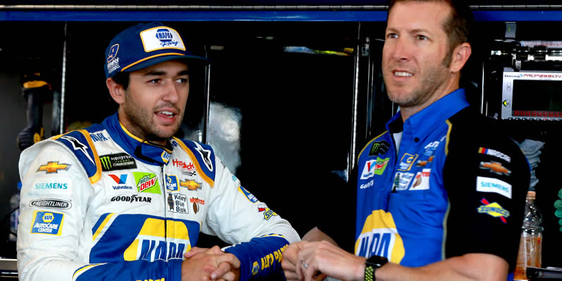Chase Elliott stands in the garage with Crew Chief Alan Gustafson