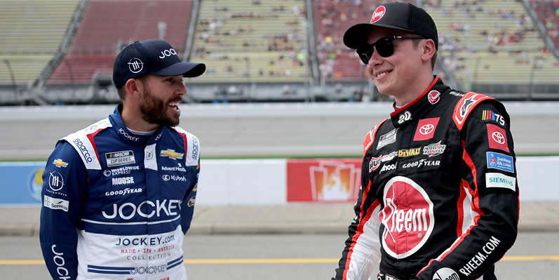 Christopher Bell and Ross Chastain share a laugh on the grid