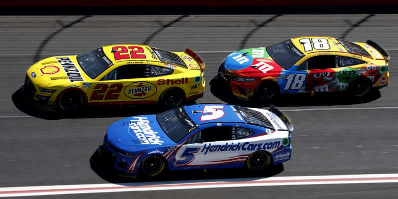 Joey Logano,  Kyle Larson and Kyle Busch drive during practice