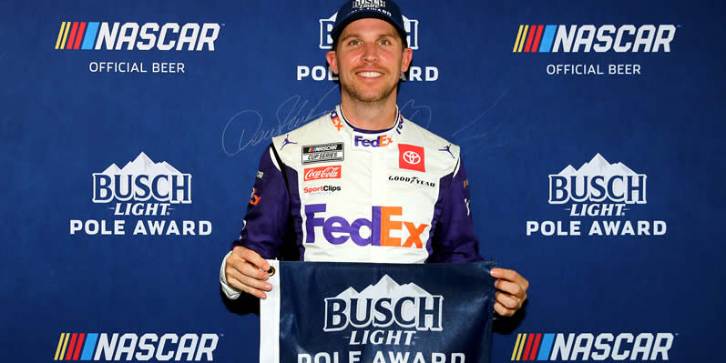 Denny Hamlin poses for photos after winning the pole