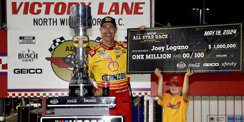 Joey Logano celebrates with the one million dollar check