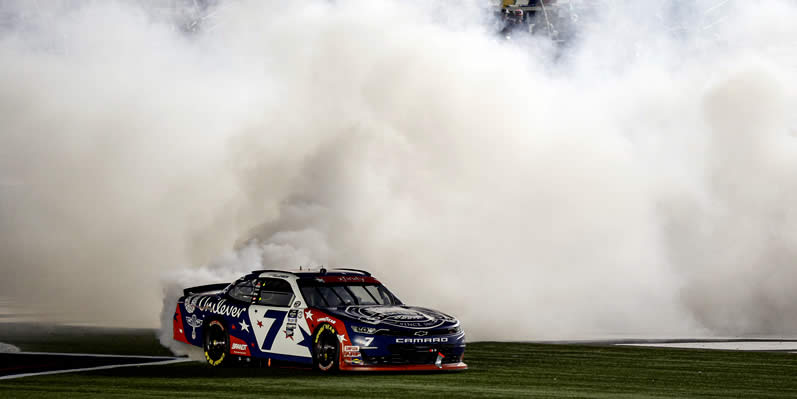 Justin Allgaier celebrates with a burnout after winning