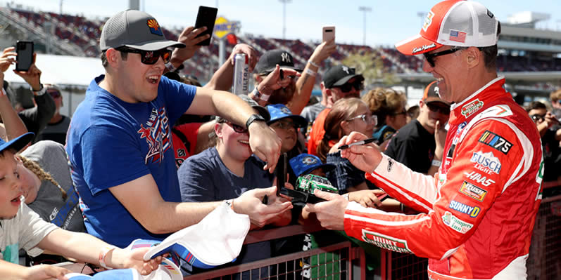 Kevin Harvick signs autographs for fans