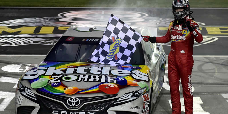 Kyle Busch celebrates with the checkered flag