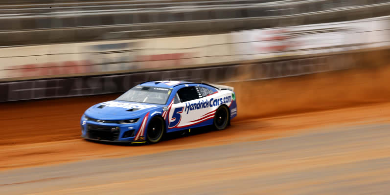 Kyle Larson drives during first practice