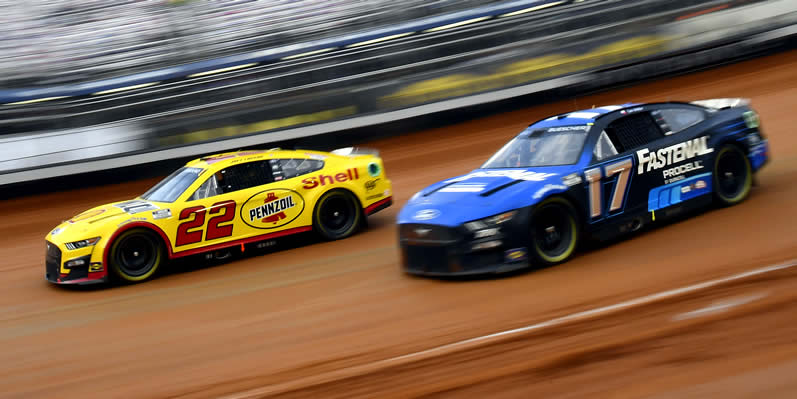 Joey Logano and Chris Buescher race during qualifying