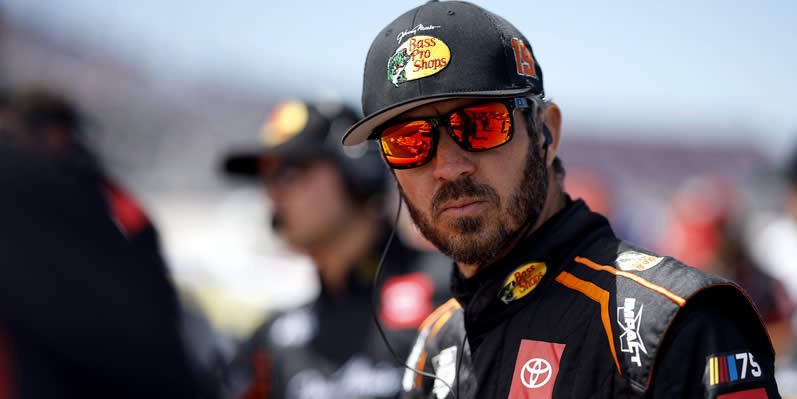 Martin Truex Jr waits with his crew on the grid