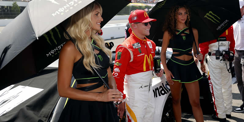 Ty Gibbs poses with Monster Energy models on the grid