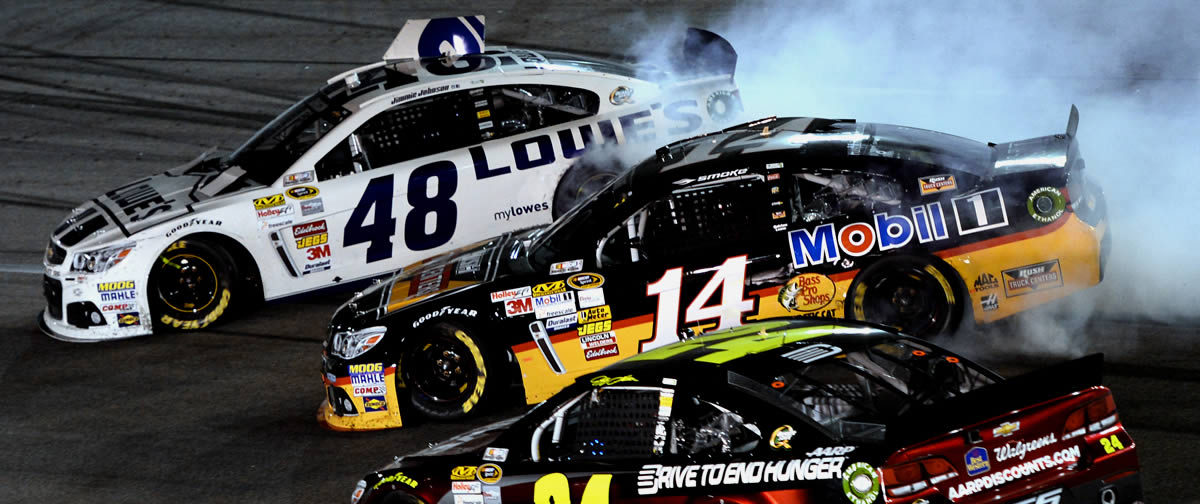 Jimmie Johnson, driver of the #48 Lowe's Dover White Chevrolet, and Tony Stewart, driver of the #14 Rush Truck Centers/Mobil 1 Chevrolet, spin after an on track incident during the NASCAR Sprint Cup Series Toyota Owners 400 at Richmond International Raceway