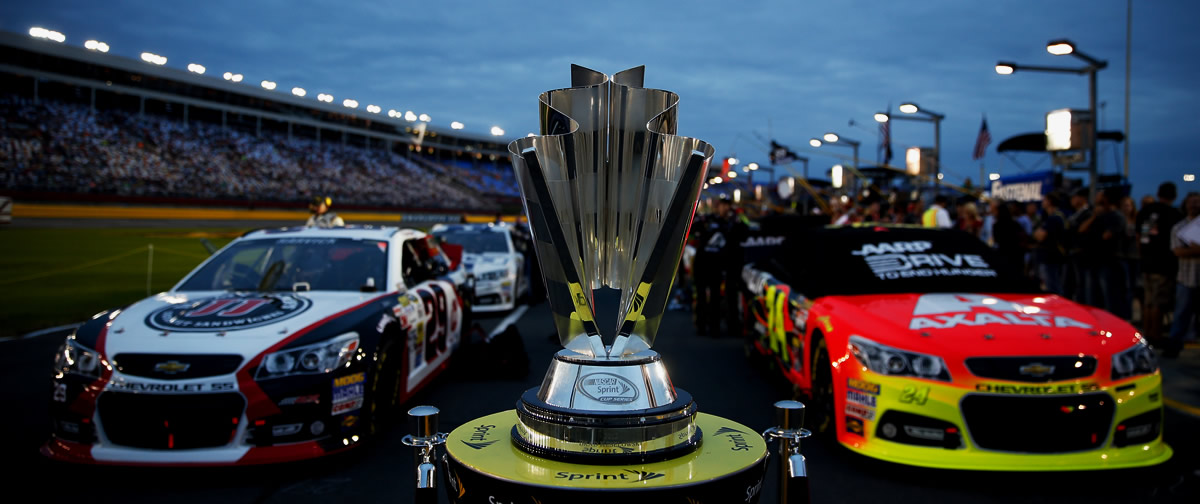 Kevin Harvick and Jeff Gordon line-up in front of Sprint Cup trophy at Charlotte