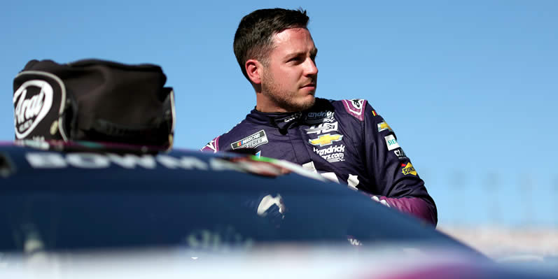 Alex Bowman enters his car during qualifying