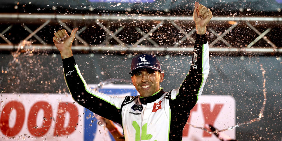 Aric Almirola celebrates in victory lane after winning the Food City 300