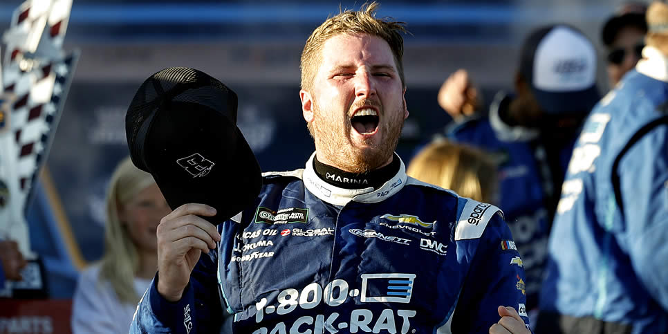 Austin Hill celebrates in victory lane after winning