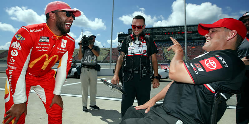 Bubba Wallace and crew chief Robert Barker celebrate