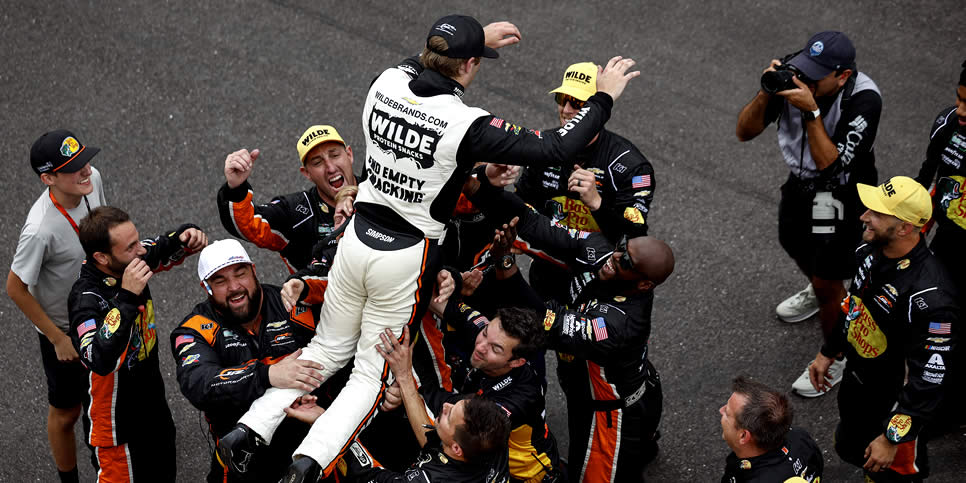 Carson Kvapil celebrates with his crew after winning