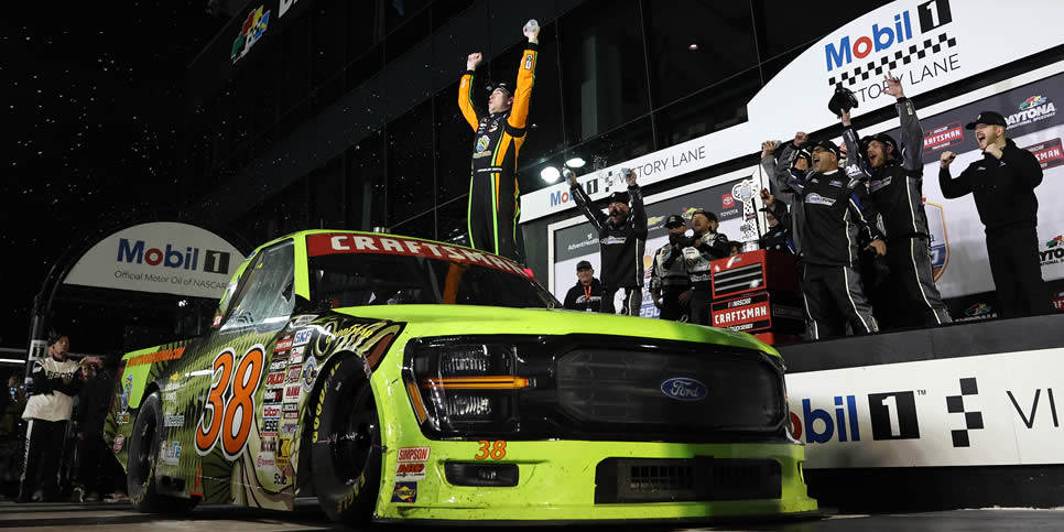 Chandler Smith celebrates in victory lane after winning