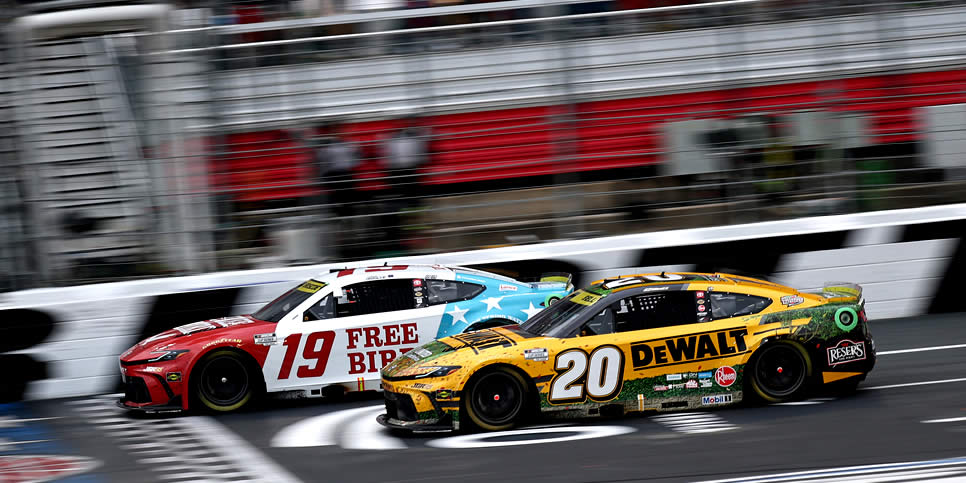 Chase Briscoe crosses the finish line ahead of Christopher Bell to win the Bank of America 400