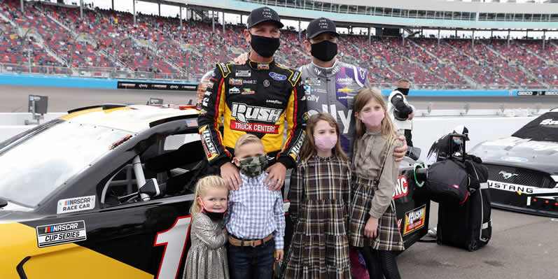 Clint Bowyer and Jimmie Johnson pose with their children