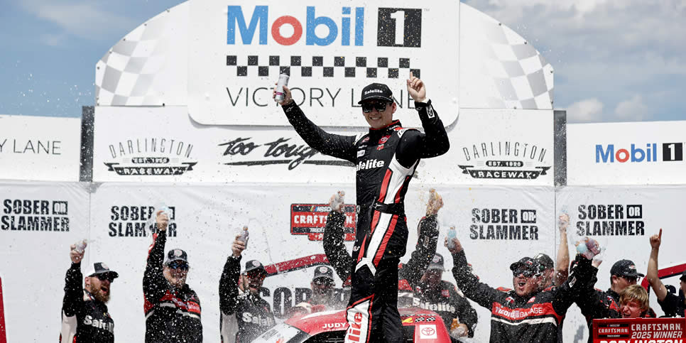 Corey Heim celebrates in victory lane after winning