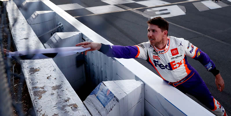 Denny Hamlin celebrates after winning