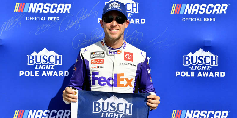 Denny Hamlin poses for photos after winning the pole award