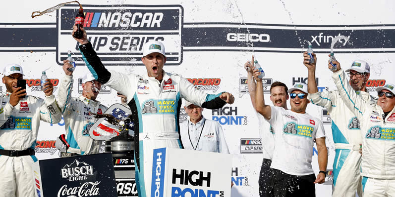 Denny Hamlin celebrates in victory lane after winning