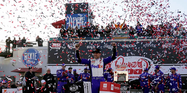 Denny Hamlin celebrates in the Ruoff Mortgage victory lane