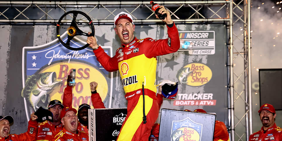 Joey Logano celebrates in victory lane after winning the Bass Pro Shops Night Race