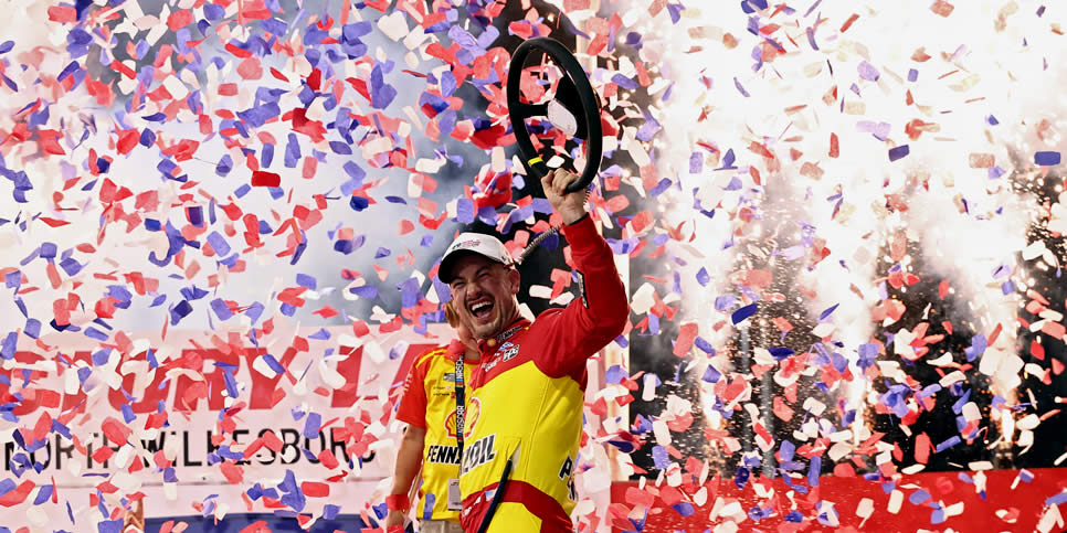 Joey Logano celebrates in victory lane after winning