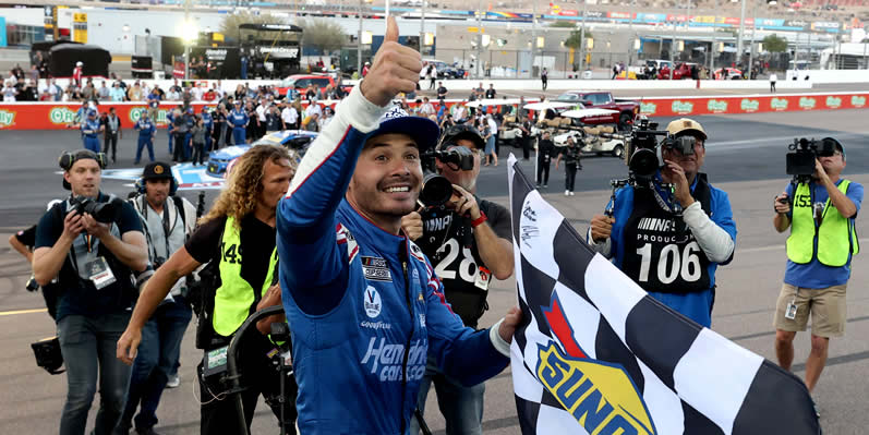 Kyle Larson celebrates with the checkered flag