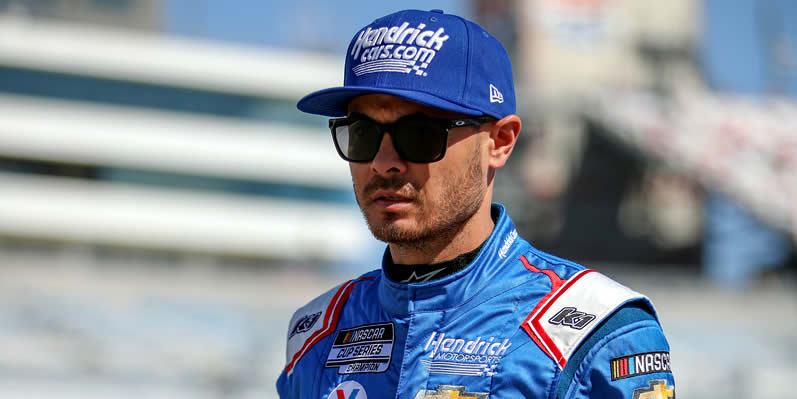 Kyle Larson walks the grid during practice