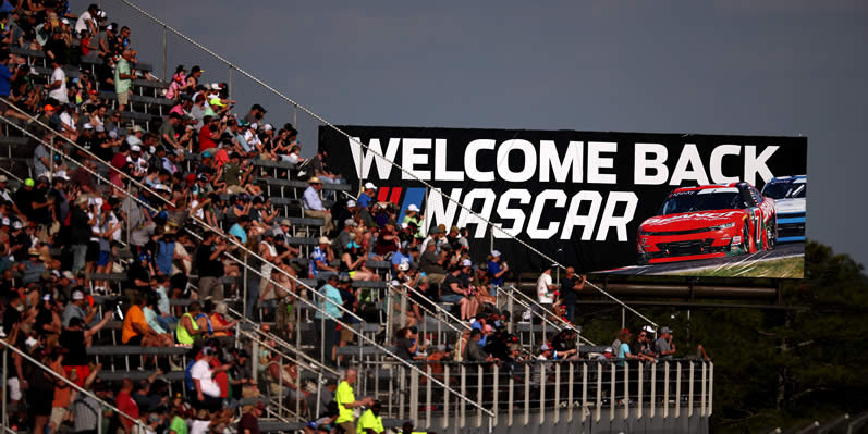 "WELCOME BACK NASCAR" billboard and the grandstands