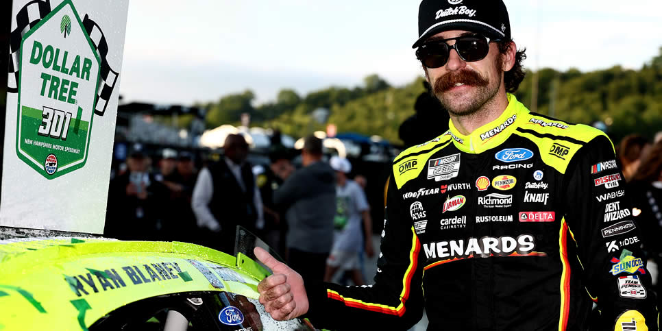 Ryan Blaney poses with the winner sticker on his car in victory lane